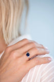 R1805-S NIXI Rhodium clear baguette cz and sapphire blue round claw set ring